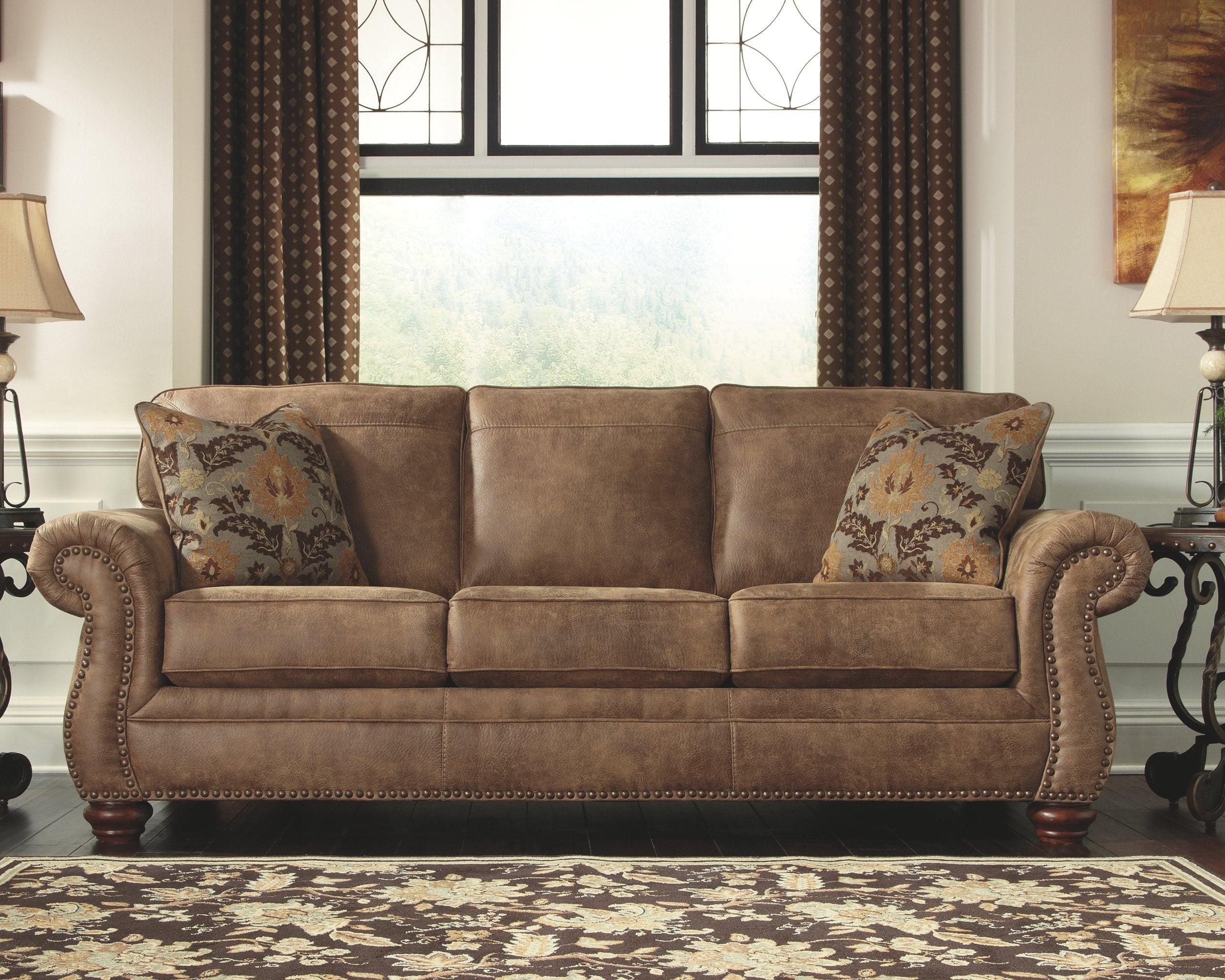 Signature Design by Ashley Larkinhurst Faux Leather Sofa with Nailhead Trim and 2 Accent Pillows, Brown
