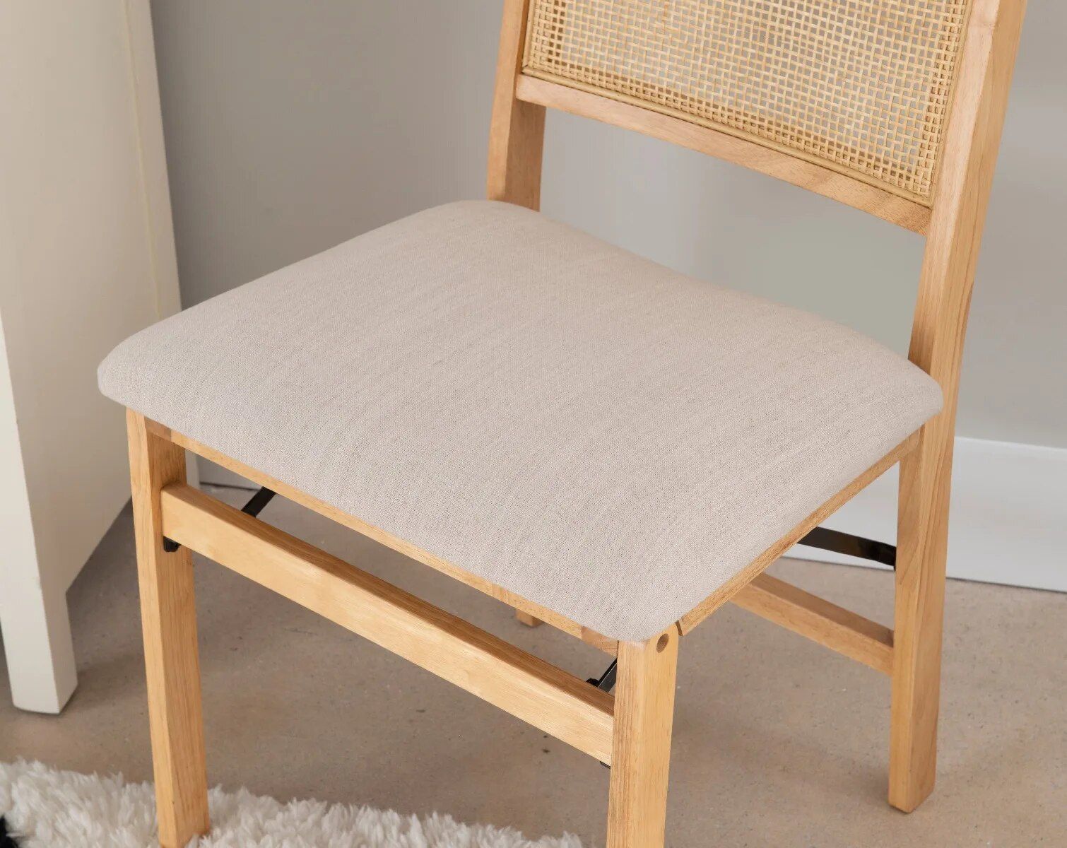 Elegant Natural Wood and Rattan Folding Chair with Upholstered Beige Seat