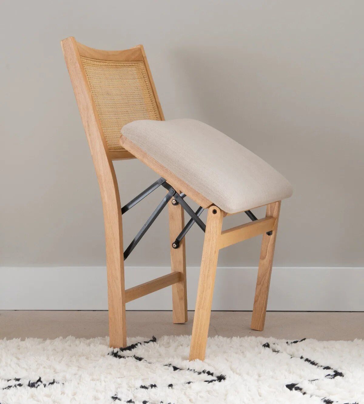 Elegant Natural Wood and Rattan Folding Chair with Upholstered Beige Seat